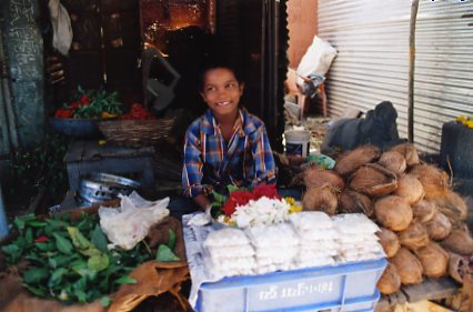 ココナツを売る男の子。インドの子どもはよく働く
